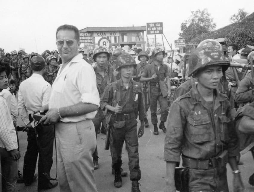 Bernard Falls stands among walking soldiers