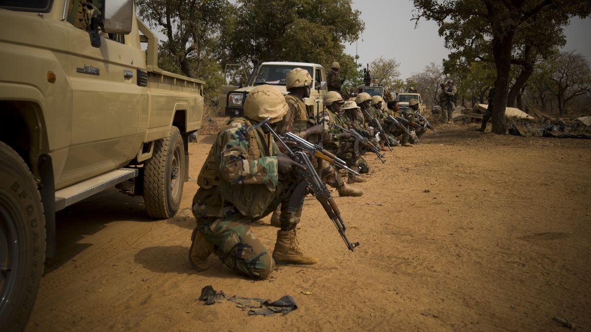 Nigerien soldiers wait for instructions before attacking a enemy command and control node, during training at Camp Po, Burkina Faso