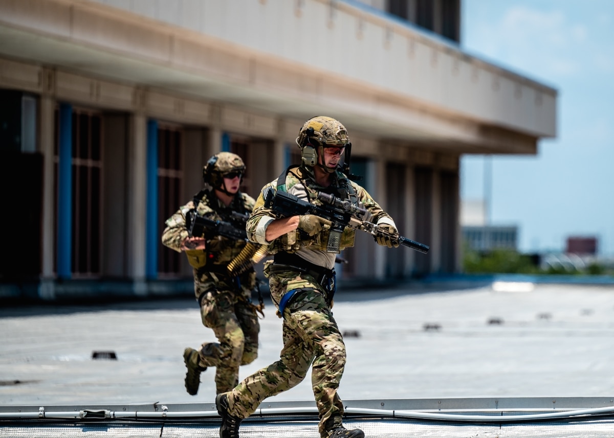 Two U.S. Special Operations Forces members sprint to their positions during a SOF capabilities demonstration