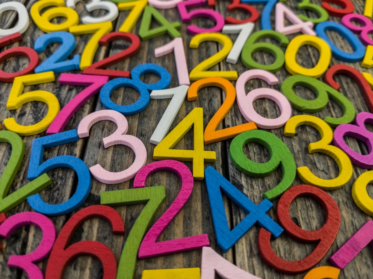 photograph with many multicolored numbers and gray background