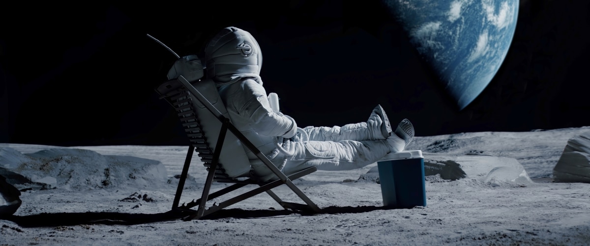 Lunar astronaut chilling on a beach chair with refrigerator bag on Moon surface, enjoying view of Earth