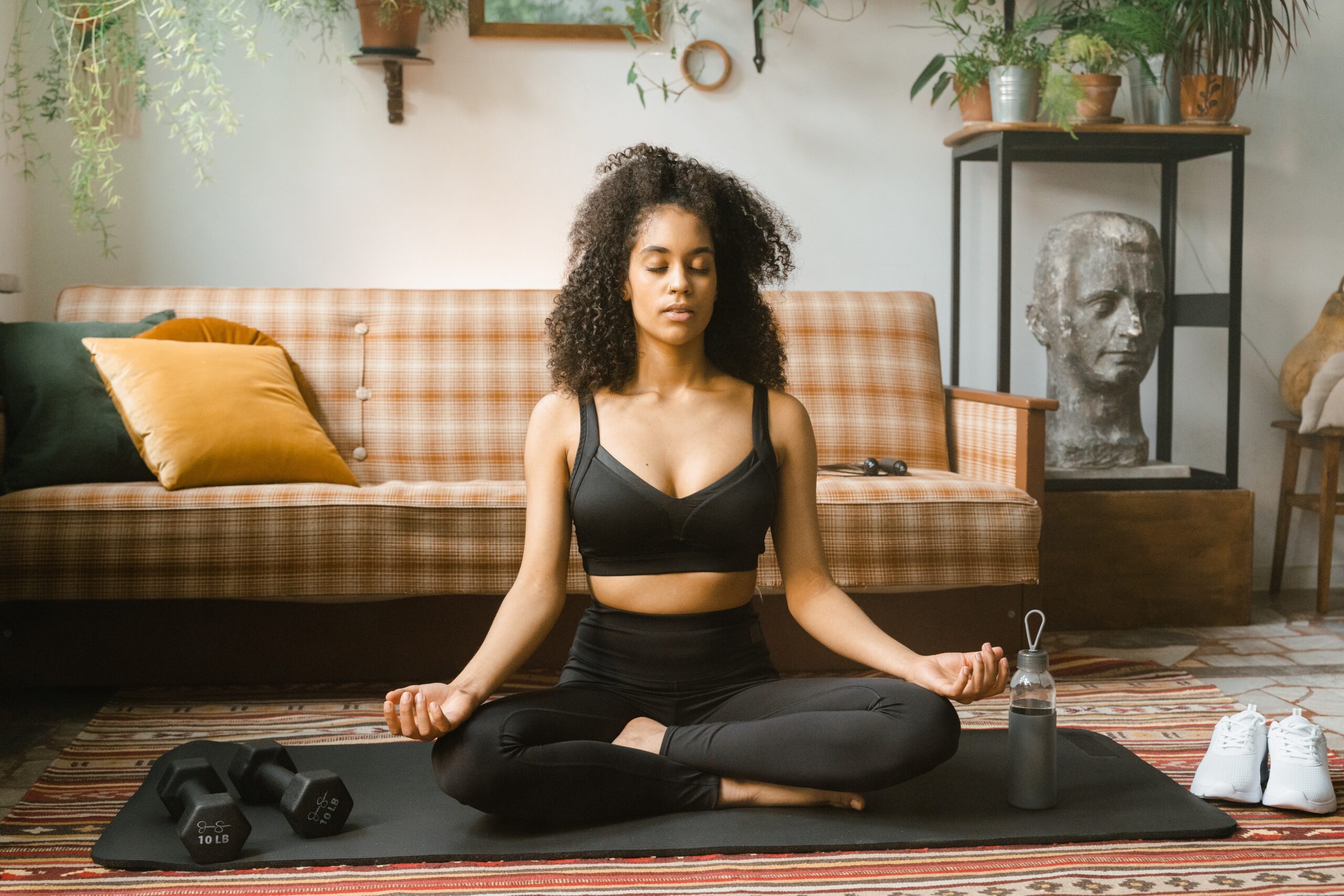 woman-in-black-activewear-meditating-indoors