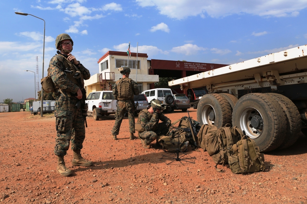Sgt. John T. Kelly, left, a radio operator with Special-Purpose Marine Air-Ground Task Force Crisis Response, calls in a status update during an evacuation of personnel from the U.S. Embassy