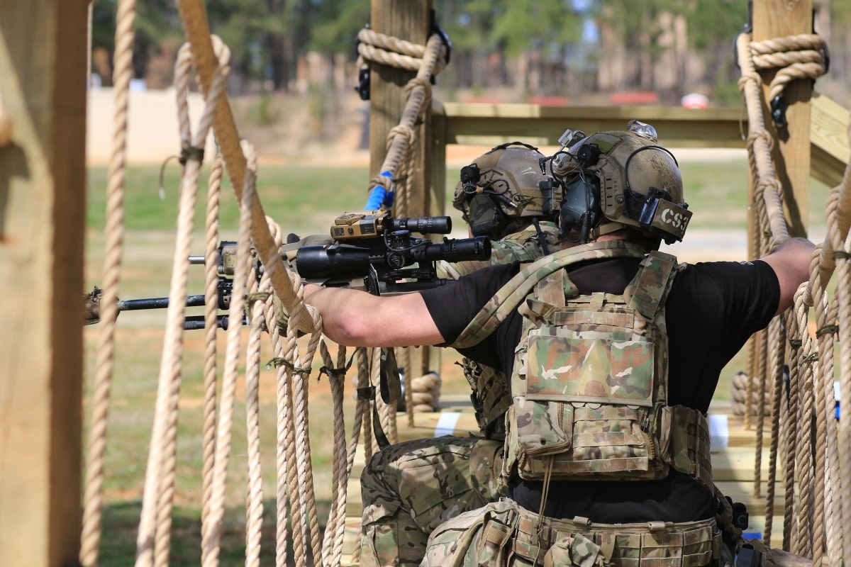 Competitors in the United States Army Special Operations Command International Sniper Competition engage targets on an obstacle course during a live-fire range event on Fort Bragg