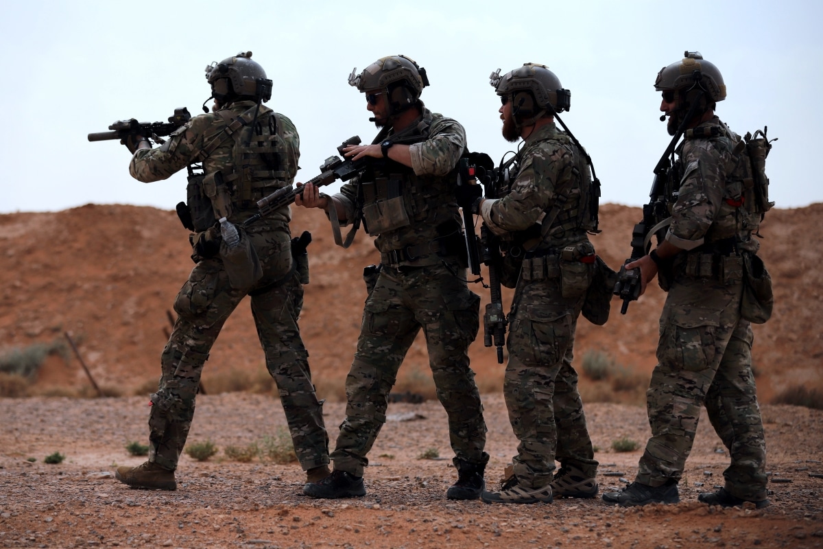 Green Berets prepare to breach an entryway during a readiness exercise near At-Tanf Garrison, Syria