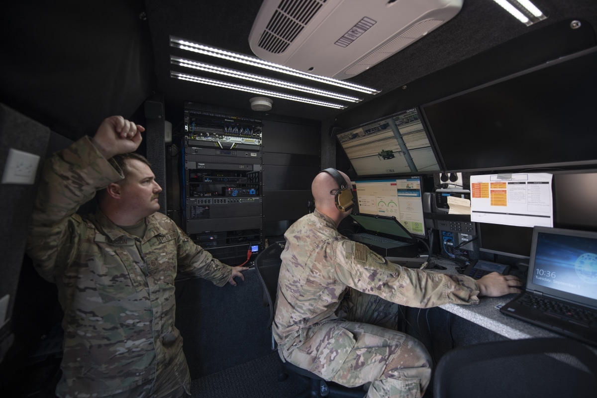 Master Sgt. Kyle Pearson (left), Headquarters Air Mobility Command expeditionary communications functional area manager, and Tech. Sgt. Kevin Koenig, 621st Contingency Response Support Squadron tactical radio communications