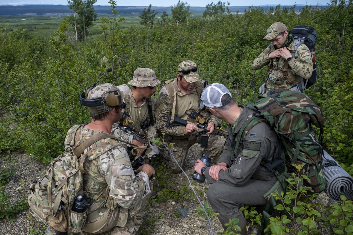 U.S. Army Green Berets from Alpha Company, 3rd Battalion, 20th Special Forces Group (Airborne) discuss their plan for exfiltration during a personnel recovery operation