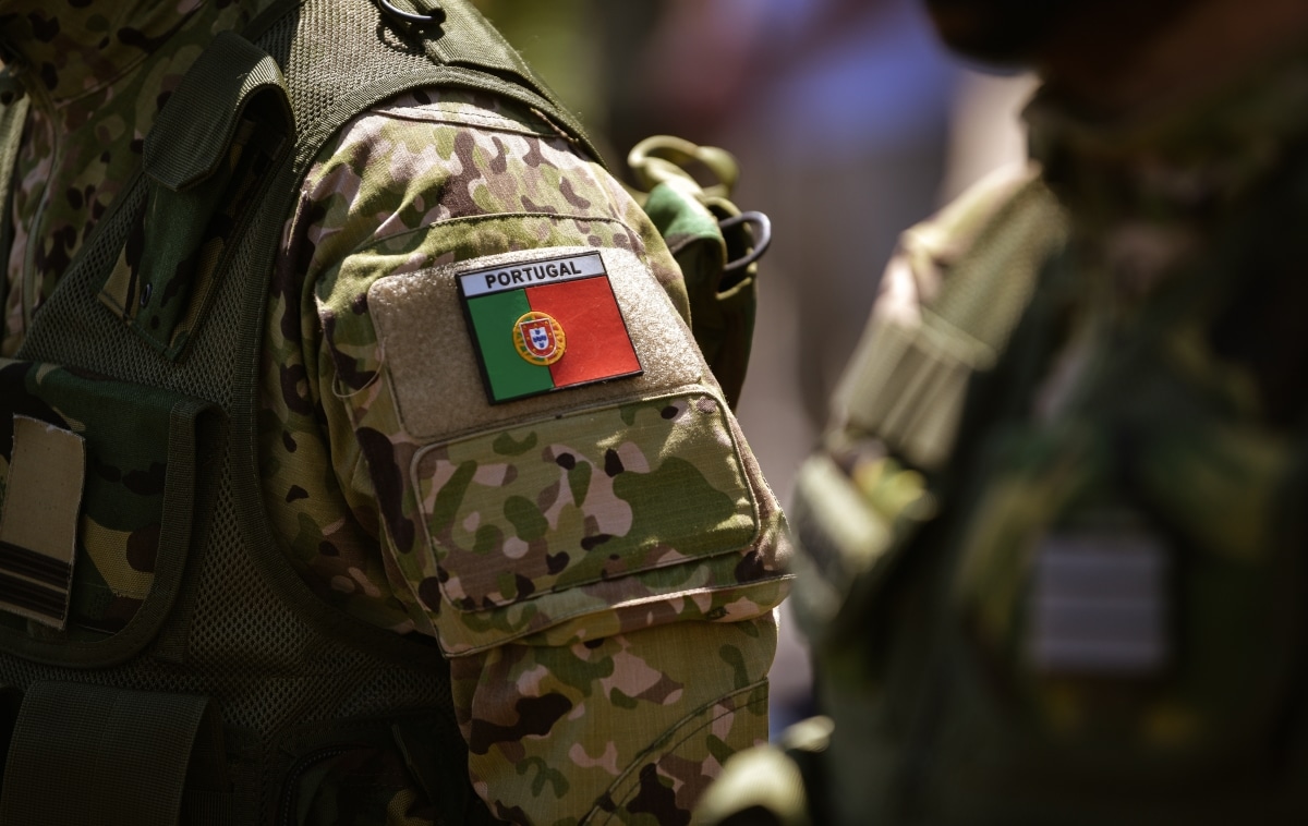 Detail view of the Portuguese Army uniform worn by soldiers in a military base. Flag of Portugal on the uniform.