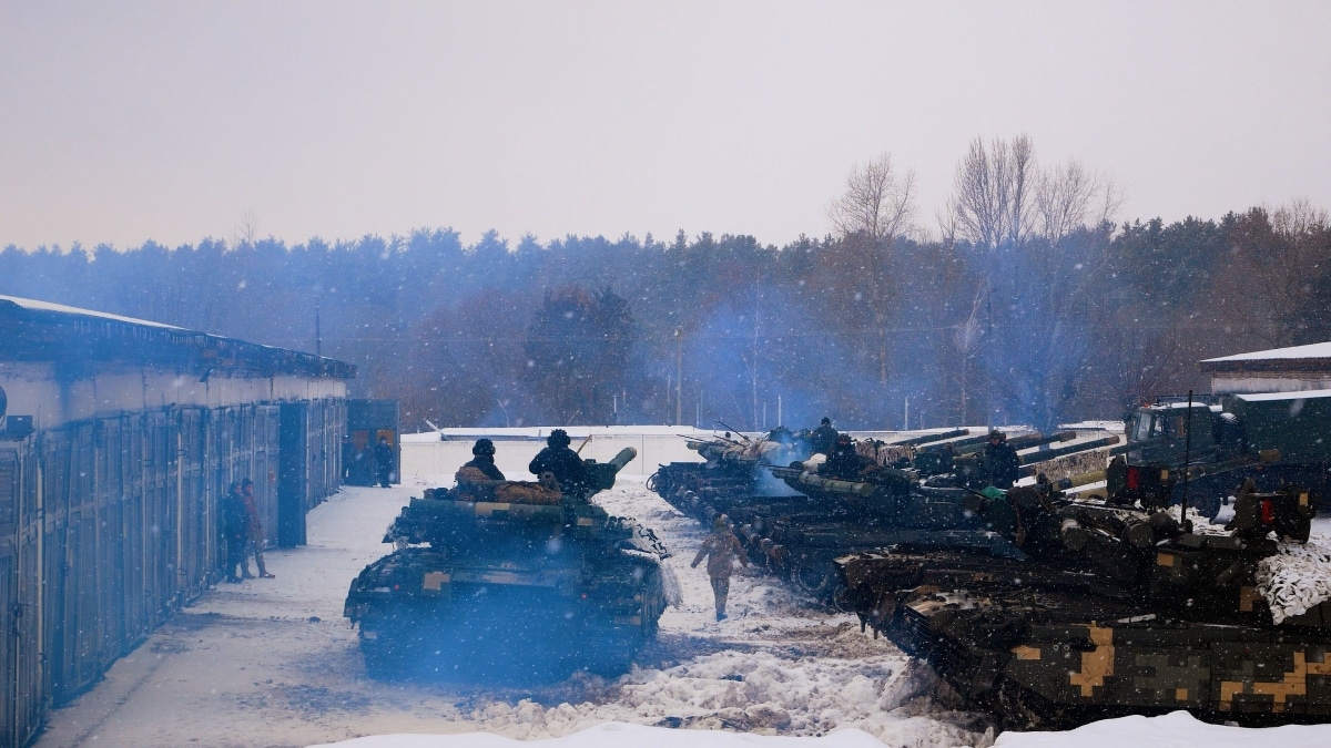 Kharkiv, Ukraine - January, 31, 2022: A tank with tankers on armor leaves the hangar on a combat mission