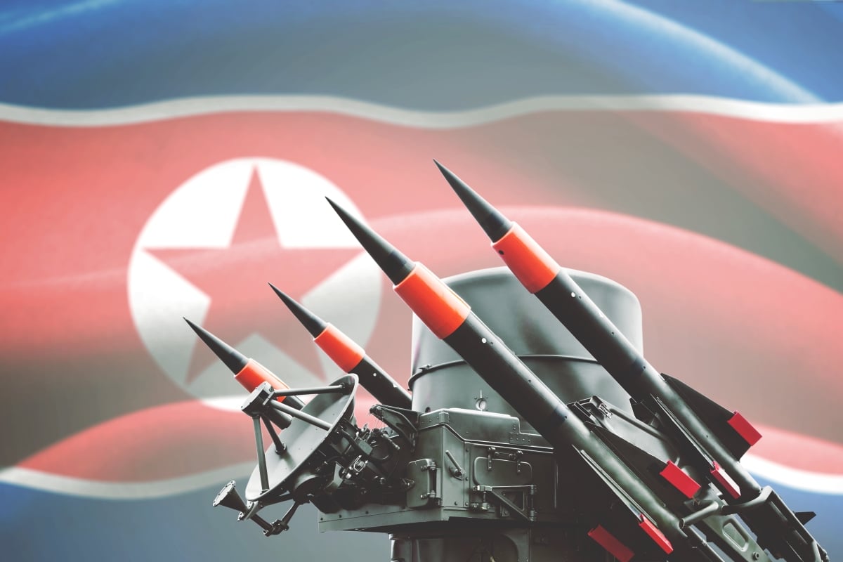 Picture of nuclear weapon for mass destruction with North Korea flag in the background