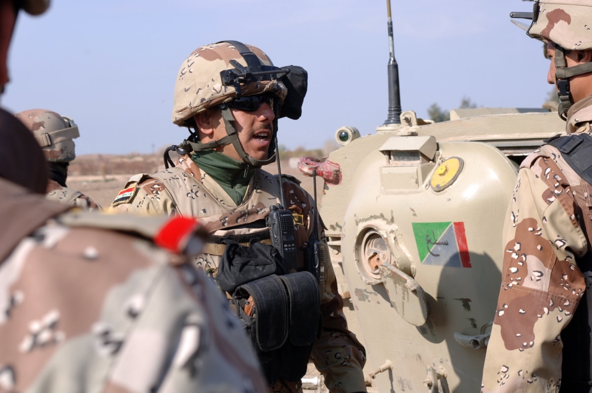 An Iraqi sergeant barks orders to his troops from 1st Brigade, 9th Iraqi Army Division before a cordon and search mission in the Raider Area of Operations