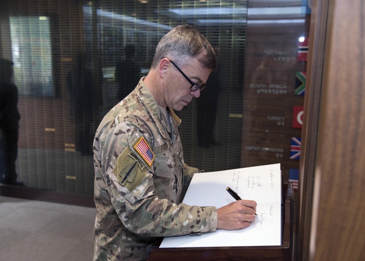 180316-N-WT427-133 BUSAN, Republic of Korea (March 16, 2018) Lt. Gen. Bryan Fenton, deputy commander, U.S. Pacific Command, signs the United Nations Memorial Ceremony in Korea guest book during a visit to Commander, U.S. Naval Forces Korea and Commander