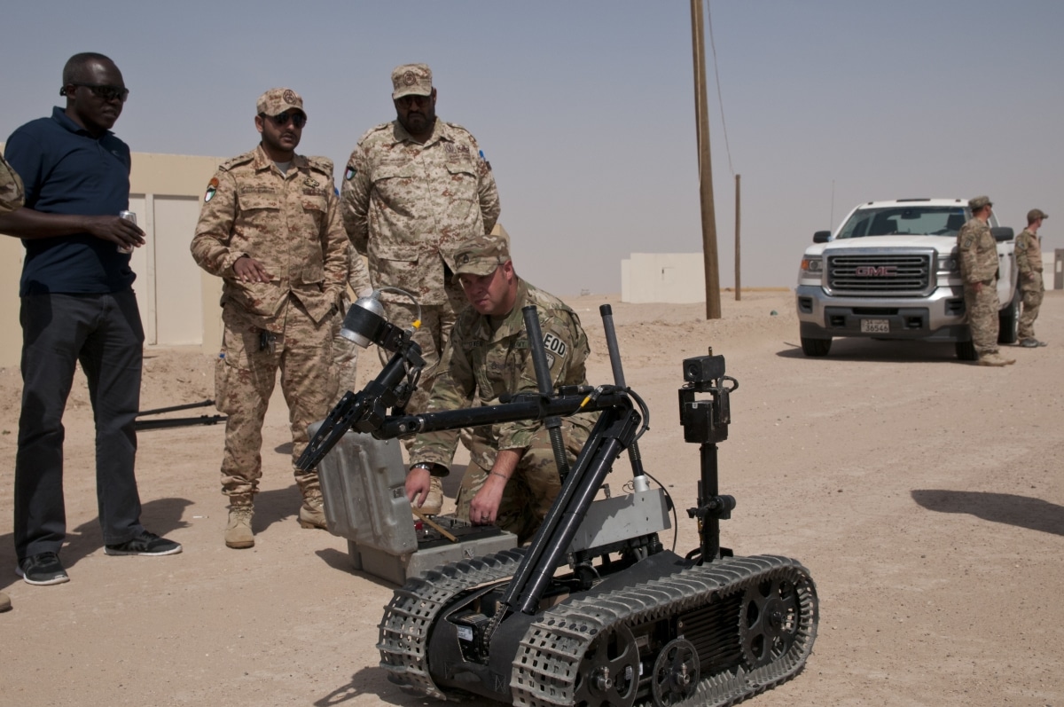 Staff Sergeant Scott Cotner, an explosive ordnance disposal technician, 797th EOD Company, drives a robot during a presentation for Kuwait Land Force officers, March 22, 2018, at Udari Range Complex near Camp Buehring, Kuwait. The presentation was part of joint training on how to best defeat IEDs and similar weapons of terror.