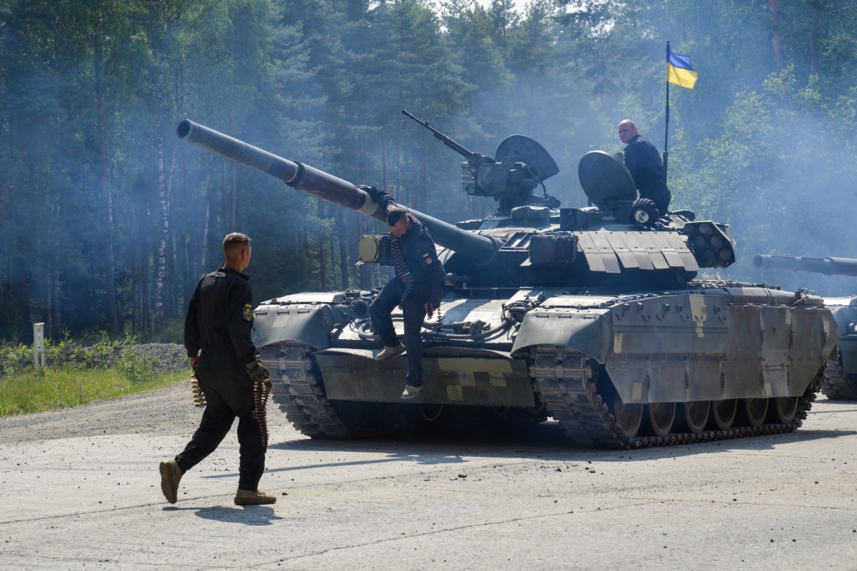 Ukrainian soldiers assigned to the 1st Tank Company, 14th Mechanized Brigade dismount from a T-84 tank after completing the Defensive Operations Lane during the Strong Europe Tank Challenge