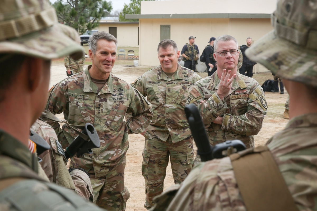 Command Chief Master Sgt. Gregory A. Smith, Senior Enlisted Leader, U.S. Special Operations Command, right, states three key points to students in the Tactical Skills phase of the Special Forces Qualification Course during a USSOCOM