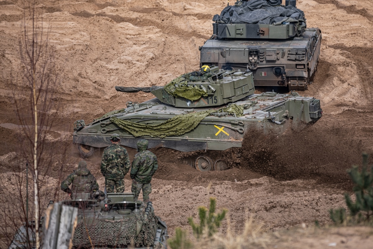 An Austrian-Spanish Cooperative Development Pizarro Armoured Infantry Fighting Vehicle assigned to the NATO eFP Battle Group Latvia, drives across the range during the Crystal Arrow distinguished visitors display to commemorate
