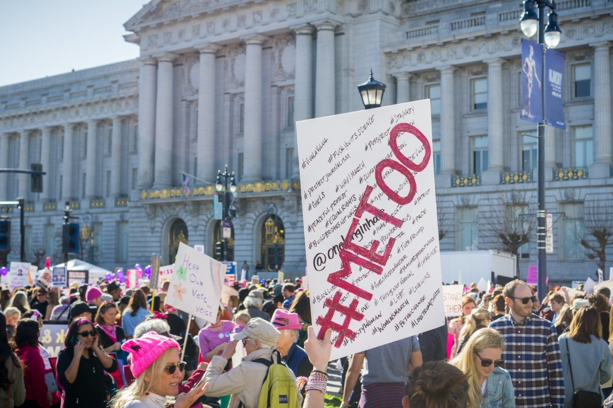 January 20, 2018 San Francisco / CA / USA - "Me too" sign raised high by a Women's March participant; the City Hall building in the background