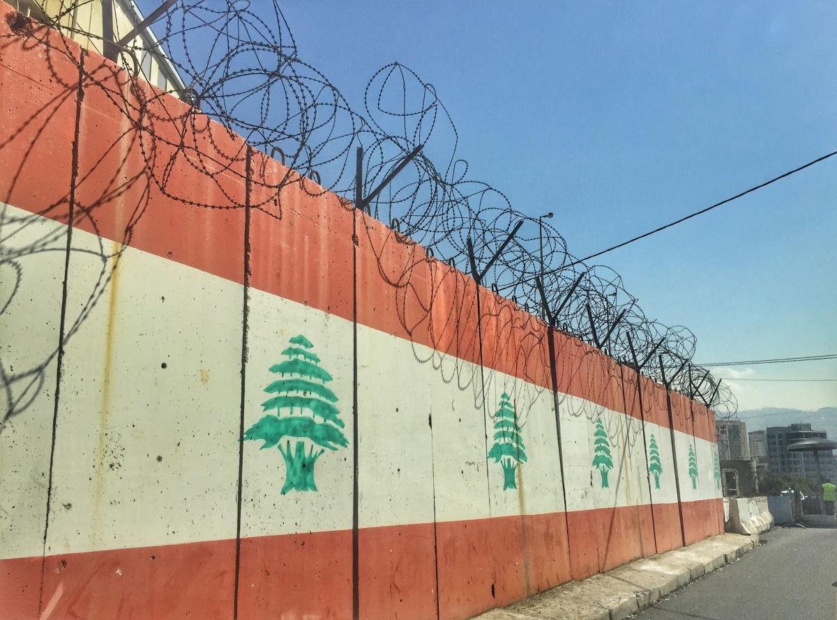 Military fence with Lebanese flag and barbed wire in Beirut, Lebanon