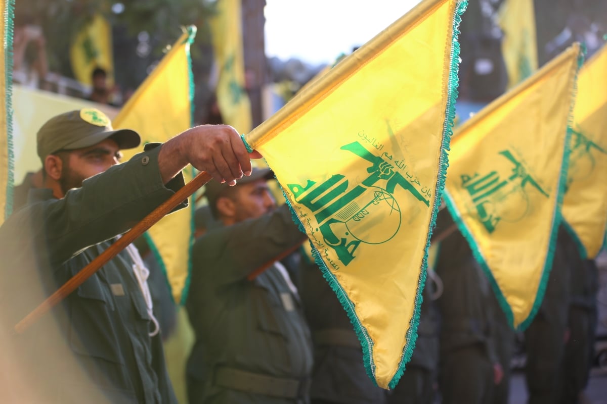 Aitit,southern Lebanon/Lebanon:1/6/2017: flags of Hezbollah with the sun shine reflection During a military salute For the funeral