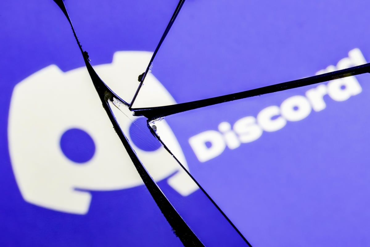 Kazan, Russia - Jan 20, 2022: Logo of the Discord social gaming platform in the reflection of a broken mirror. The concept of problems in the work of Discord.