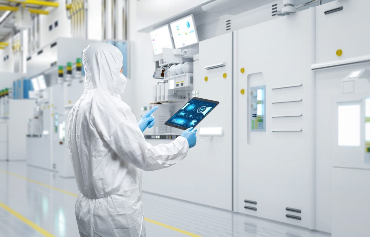 Worker or engineer wears protective suit or white coverall suit work in semiconductor manufacturing factory