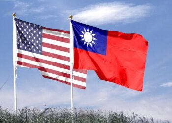 American flag with Taiwan flag on cloudy sky. waving in the sky