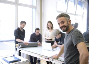 Publisher advertising agency owner working with team on a creative project.