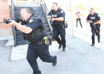 Detectives with the University of Utah Police Department respond to an active-shooter training simulation at Fort Douglas, Utah, July 17, 2014. In the event of a real-life situation, this training helps to prepare civilians, military personnel and the police department alike.