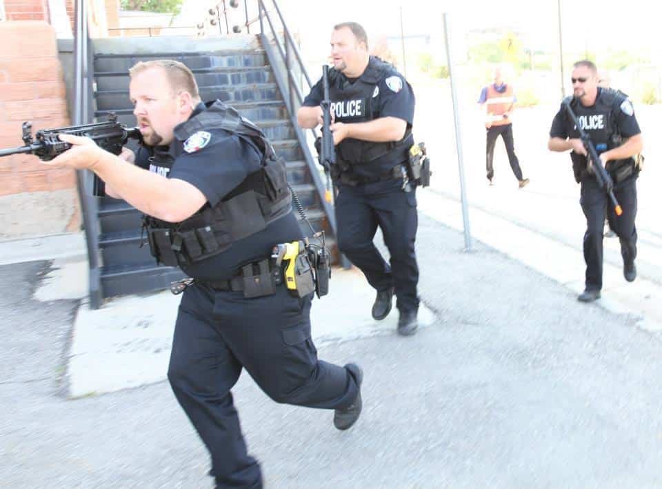 Detectives with the University of Utah Police Department respond to an active-shooter training simulation at Fort Douglas, Utah, July 17, 2014. In the event of a real-life situation, this training helps to prepare civilians, military personnel and the police department alike.
