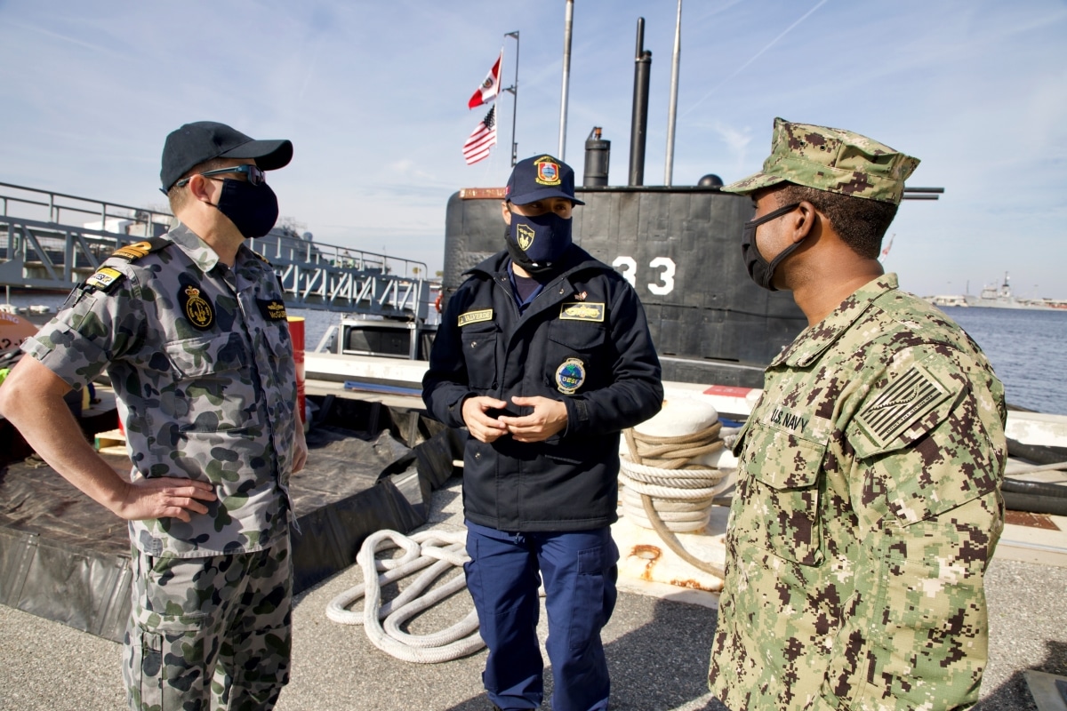 Lt. Matthew McGuire (RAN) and Lt. Reginald Caldwell speak with an officer from the Peruvian submarine BAP Pisagua (SS-33) at Naval Station Mayport. Pisagua is participating in exercises and training as part of the Diesel–Electric Submarine Initiative, now in its 20th year.