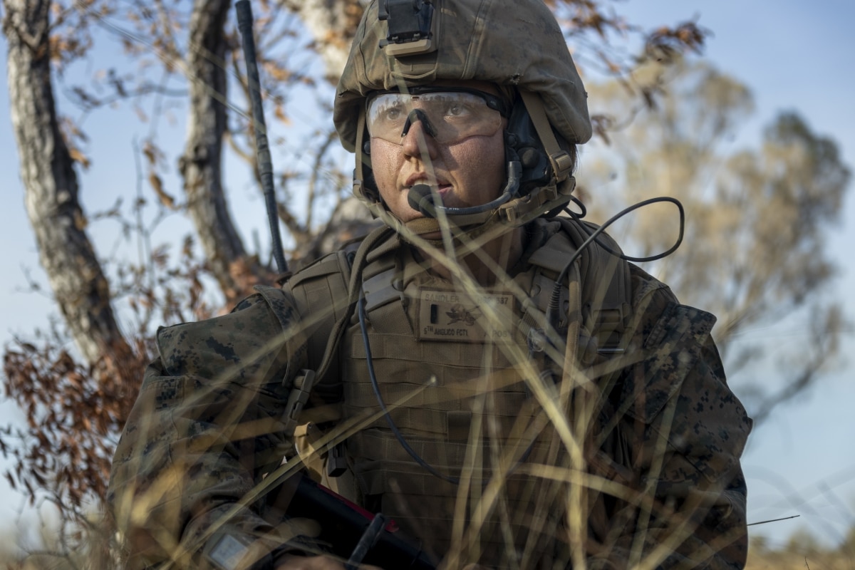 U.S. Marine Corps 1st Lt. Holly Sandler, the fire power control team leader with 5th Air Naval Gunfire Liaison Company detachment, Marine Rotational Force – Darwin, observes down range while coordinating close air support for a company attack on Objective Dingo during Exercise Koolendong, Bradshaw Field