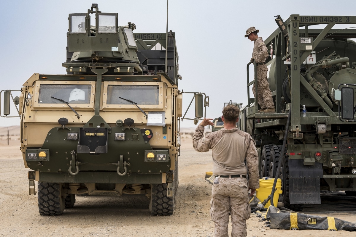 U.S. Marine Corps Lance Cpl. Benjamin Thompson, a refueler with Combat Logistics Regiment 1, 1st Marine Logistics Group, positions a LVSR AMKR18 for refueling inside a Logistics Support Area established in the Kingdom of Saudi Arabia during exercise Native Fury
