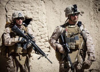U.S. Marine Corps Lance Cpl. Leo Caldwell, left, and Sgt. Jordan Hicks, right, platoon sergeant Echo company, 2nd Battalion 9th Marines, Regimental Combat Team 7 (RCT) 7, consults his teammates during a combat operation in Helmand province, Afghanistan