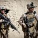 U.S. Marine Corps Lance Cpl. Leo Caldwell, left, and Sgt. Jordan Hicks, right, platoon sergeant Echo company, 2nd Battalion 9th Marines, Regimental Combat Team 7 (RCT) 7, consults his teammates during a combat operation in Helmand province, Afghanistan