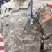 USA Army doctor with stethoscope over his neck and USA flag on background