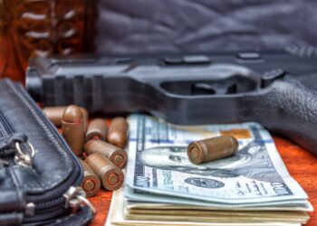 Bullets, money, weapons demonstrating the concept of a bandit. Terrorist activity.