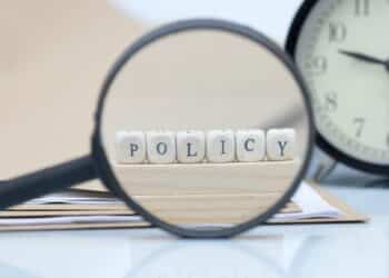 The concept of policies. Words use blocks of wood on files and documents. Selective Focus.