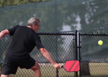 A senior competes in the singles division of a pickleball tournament