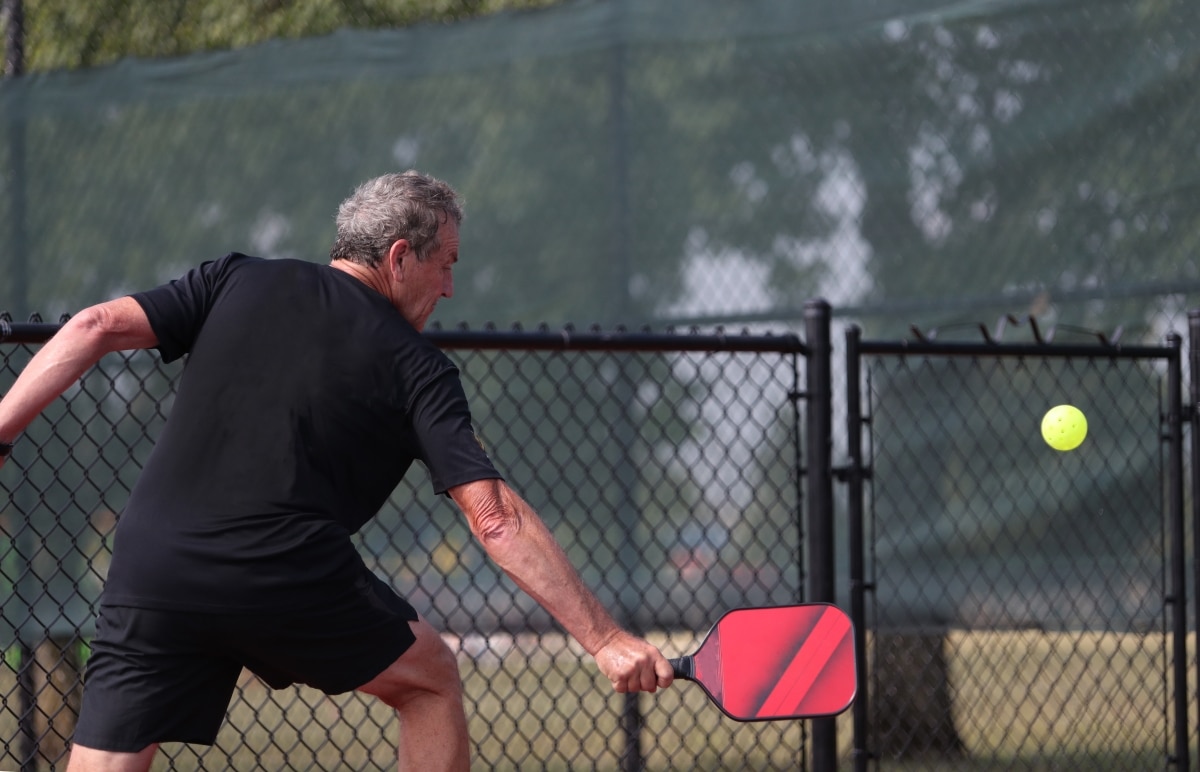 A senior competes in the singles division of a pickleball tournament