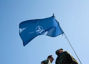 tock Photo ID: 1625063092 NATO Days, Ostrava, Czechia - September,22: NATO (North Atlantic Treaty Organization). Wavy and undulated flag of defense alliance and partnership is floating in the air.