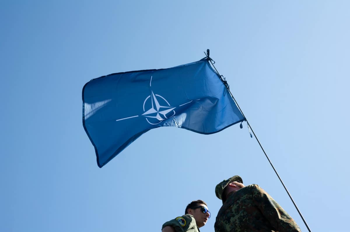 tock Photo ID: 1625063092 NATO Days, Ostrava, Czechia - September,22: NATO (North Atlantic Treaty Organization). Wavy and undulated flag of defense alliance and partnership is floating in the air.