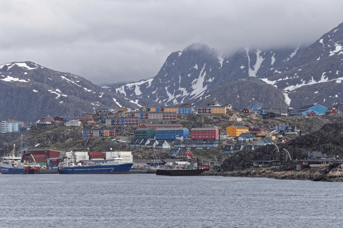 Sisimiut, Greenland - July 1st 2018: The harbour area of town with back drop of mountains. Boats are an essential form of travel in Greenland. Photos taken on a tour of Greenland's west coast.