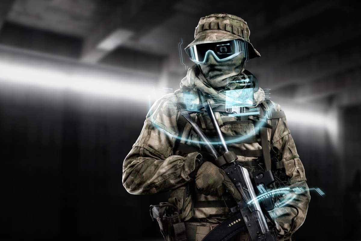 Special forces soldier with weapon in . Shot in studio. Hangar with windows on background. (cover design, military concept of the sci-fi future soldier, flip version)