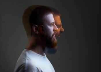 Side view portrait of two-faced man in calm serious and angry screaming expression.