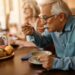 Mature man eating soup while having lunch at residential care home