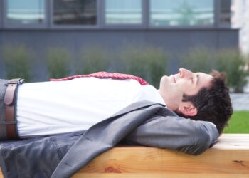 Businessman with black hair relaxing outside