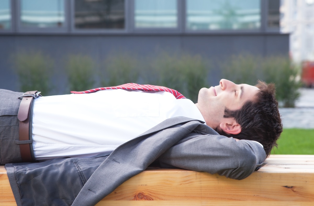 Businessman with black hair relaxing outside
