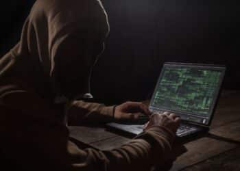 Silhouette of a hacker with laptop