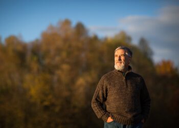 Portrait of a senior man outdoors, walking in a park (shallow DOF; color toned image)