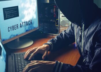 anonymous hacker with no face in the darkness, breaks the access to steal information and infect computers and systems. the concept of hacking and cyber war